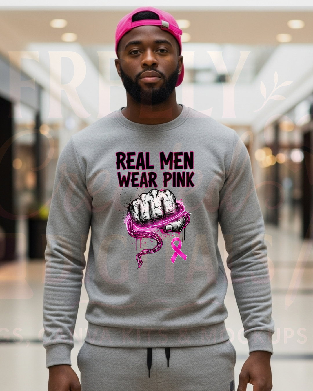 Man wearing a gray sweatshirt with 'Real Men Wear Pink' graphic in a mall setting